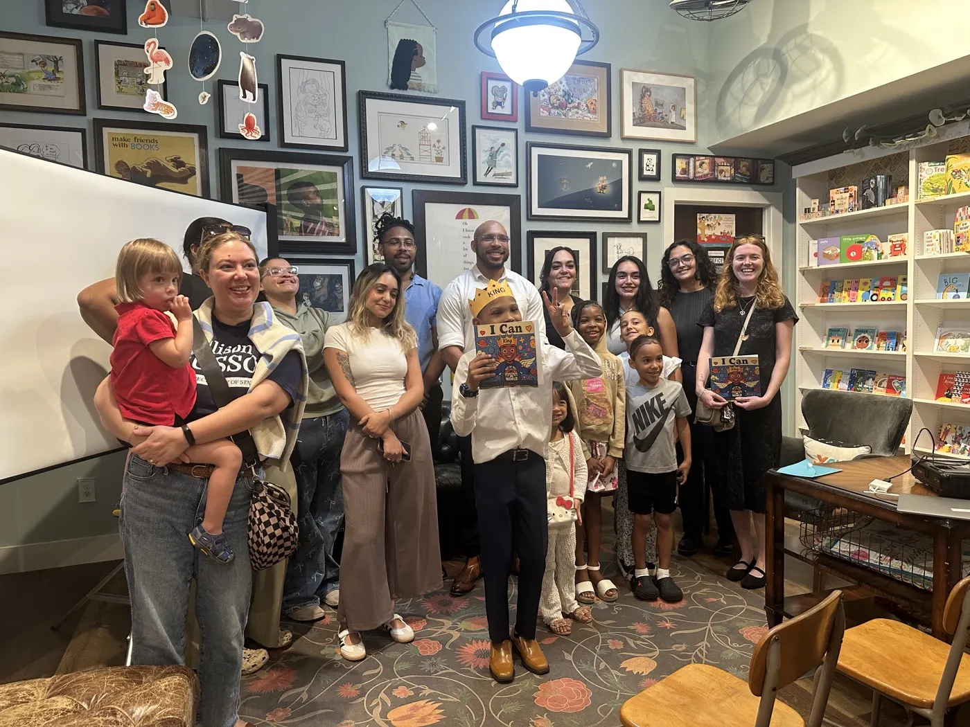 A group photo of everyone who came to Titan's first author event, gathered together inside the bookstore with Titan holding his book at the centre.